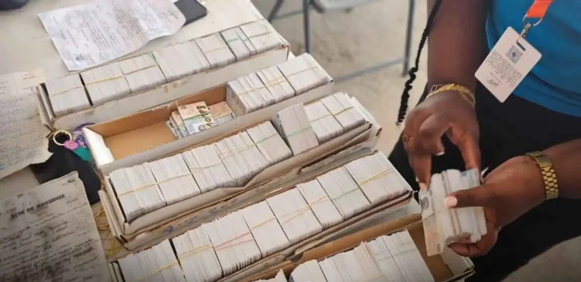 A person organizing stacks of currency notes and documents on a table, highlighting the process of handling cash and paperwork in a financial or administrative setting.