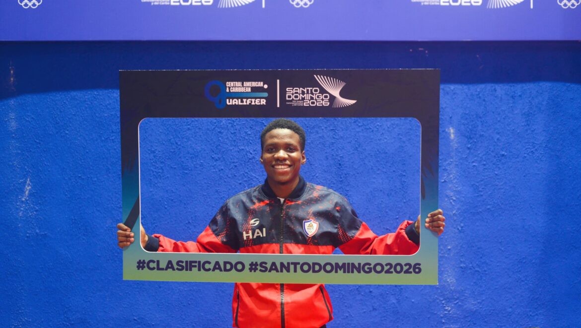 Young athlete celebrating qualification for the Central American and Caribbean Games in Santo Domingo 2026, holding a sign that reads "#CLASIFICADO" against a vibrant blue background.